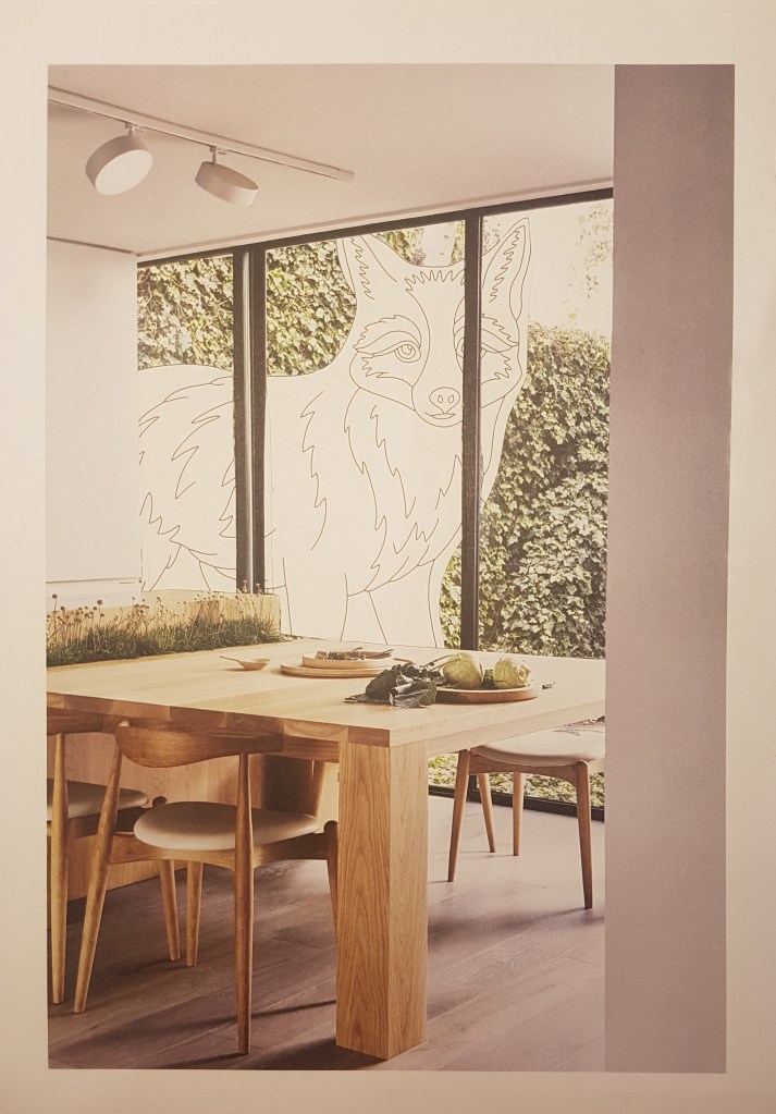 Collage. Image of a giant paper fox from a paint-by-numbers colouring book outside a scandi designer interior.